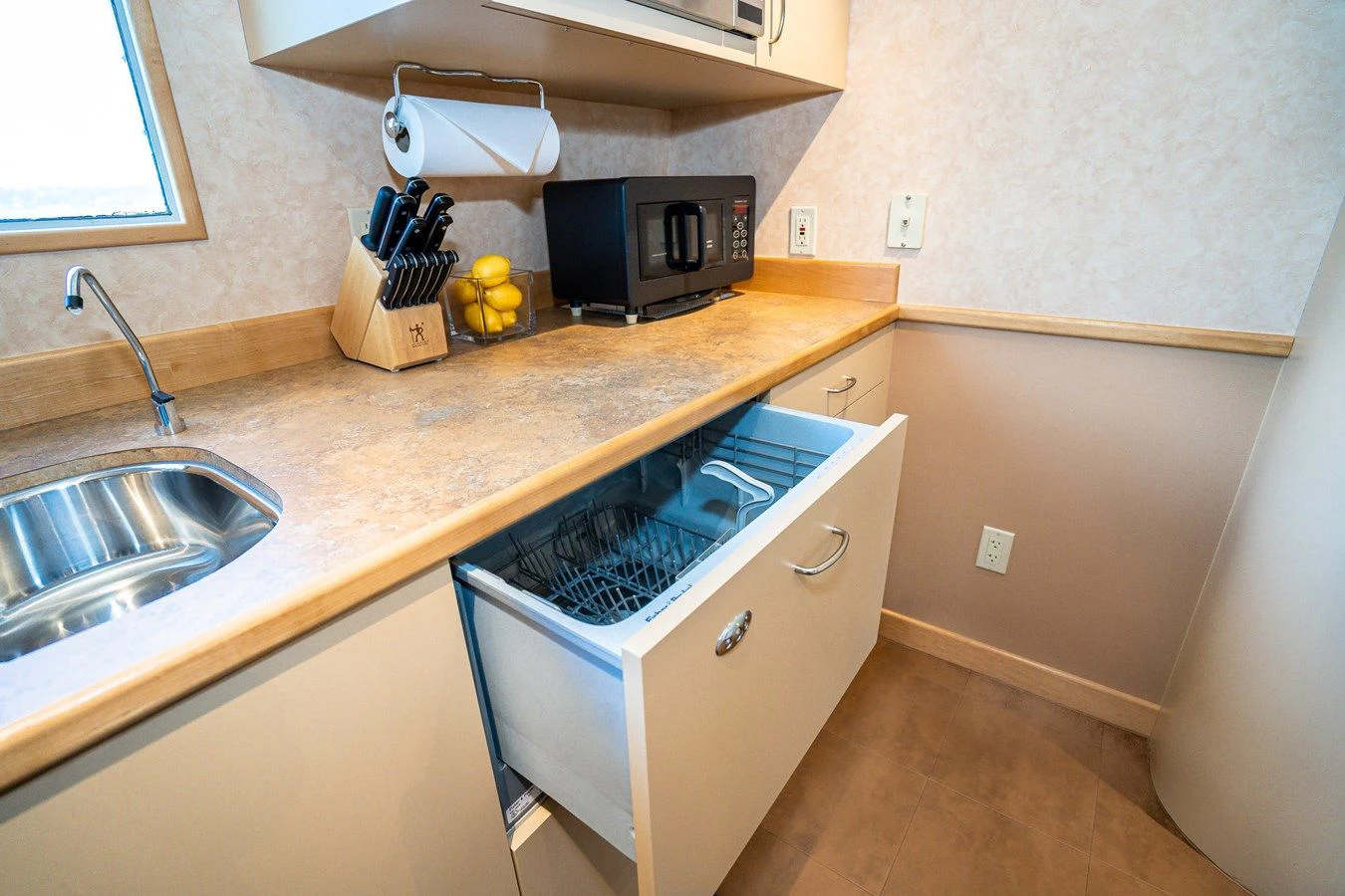 a kitchen with a microwave oven and a sink aboard DRAGONFLY Yacht for Sale
