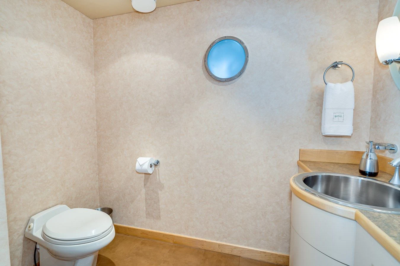 a bathroom with a toilet and sink aboard DRAGONFLY Yacht for Sale