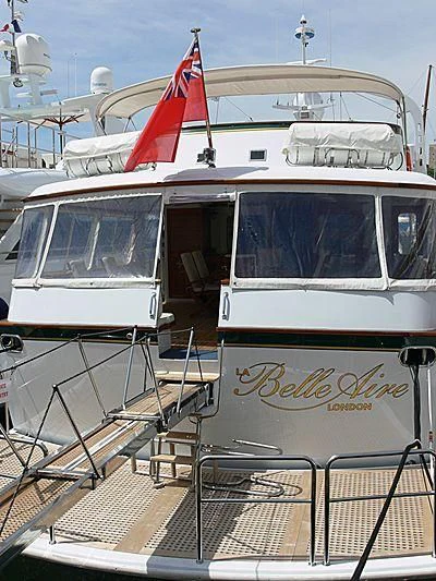 a boat with a flag on the front aboard LELOU Yacht for Sale