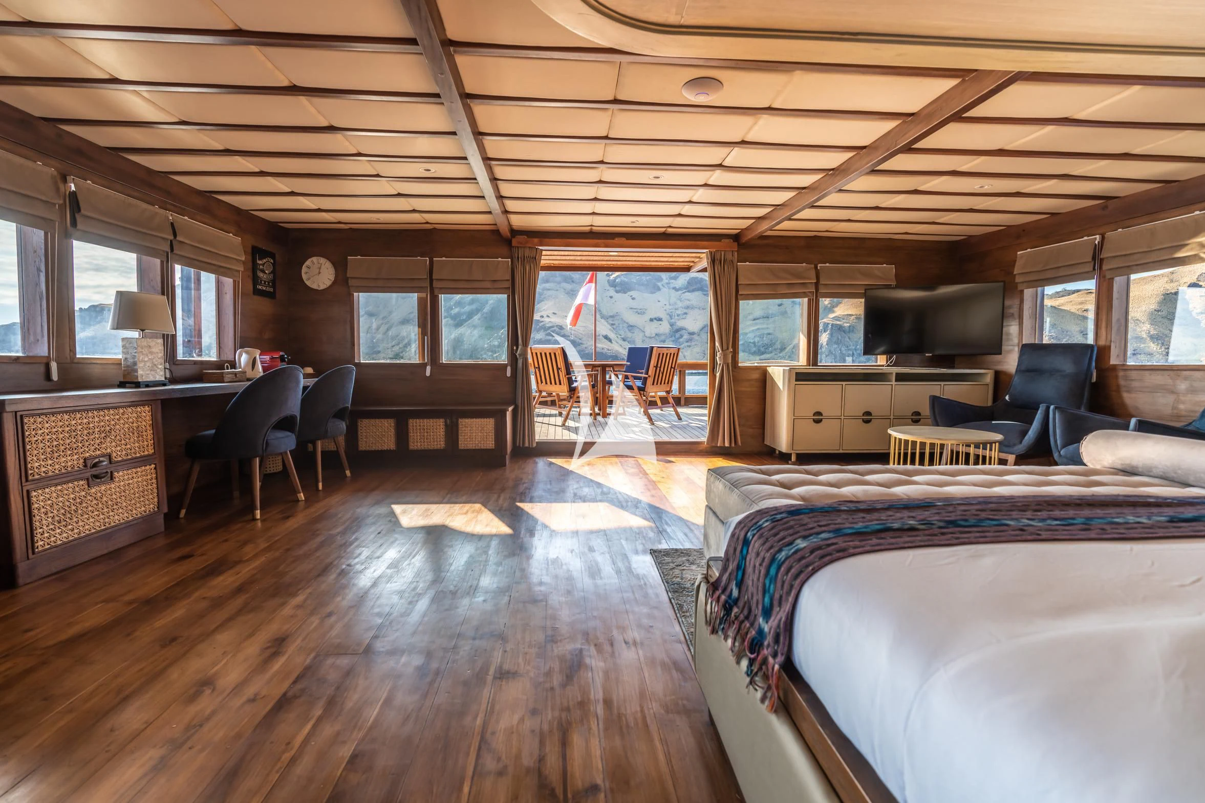 a bedroom with a wood floor aboard THE MAJ OCEANIC Yacht for Charter