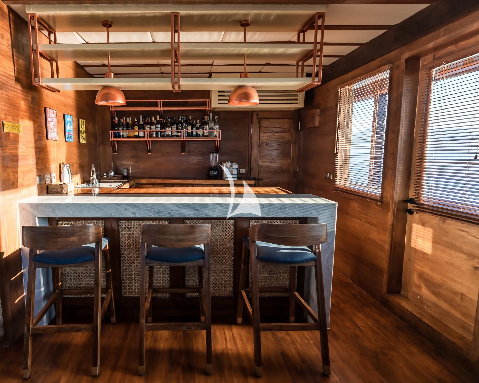 a bar with a bar and chairs aboard THE MAJ OCEANIC Yacht for Charter