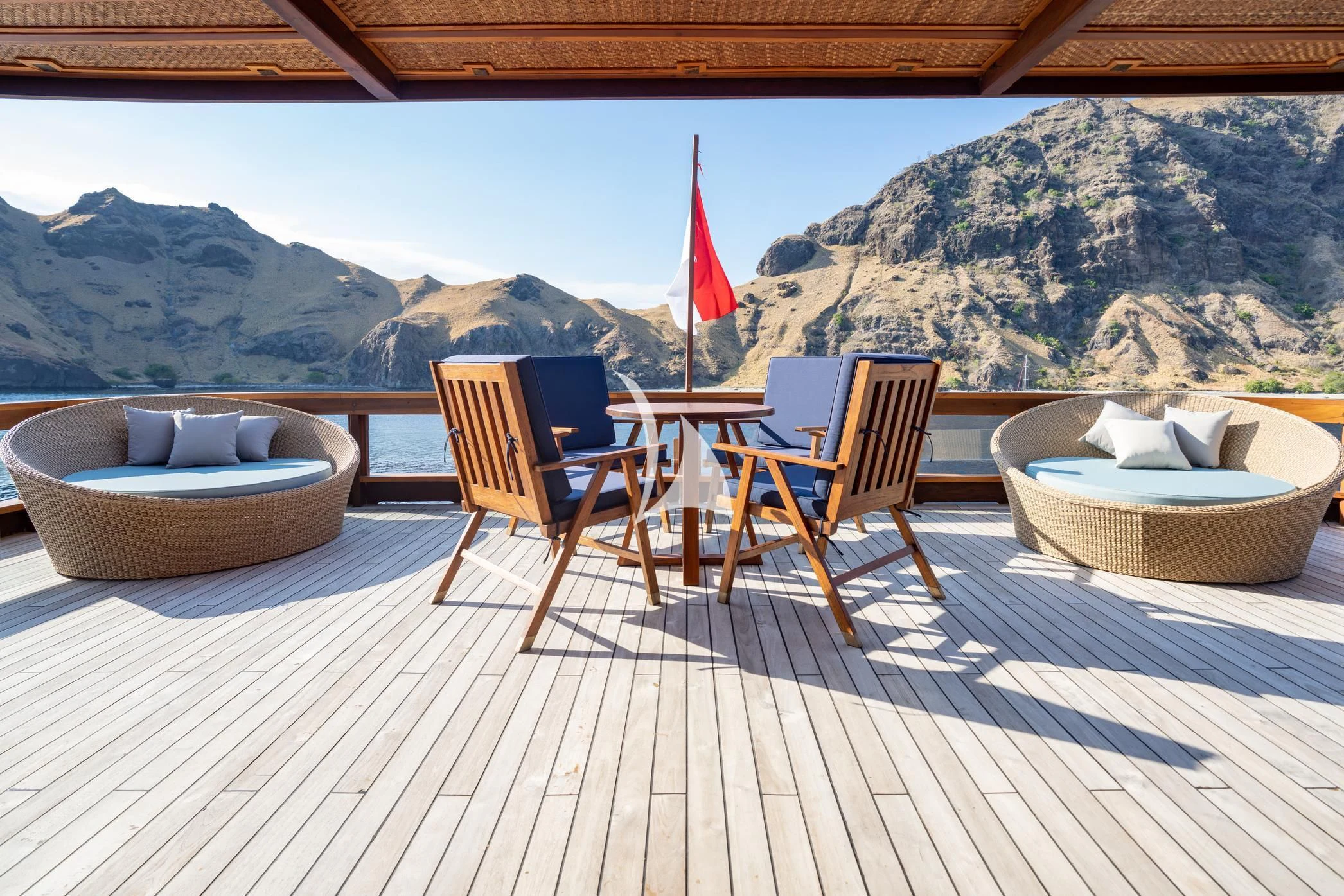a patio with chairs and a table aboard THE MAJ OCEANIC Yacht for Charter