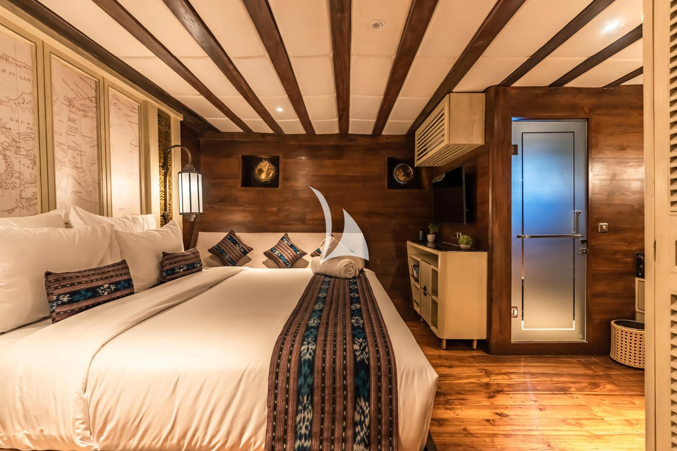 a bedroom with a bed and a blue door aboard THE MAJ OCEANIC Yacht for Charter