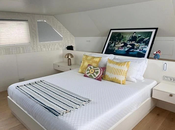 a bed with pillows and blankets aboard VIKA Yacht for Sale