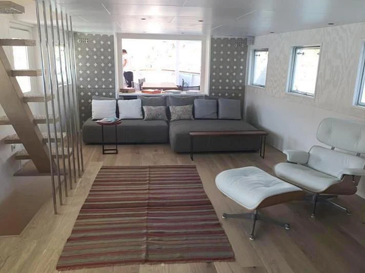 a living room with a couch and a table aboard VIKA Yacht for Sale