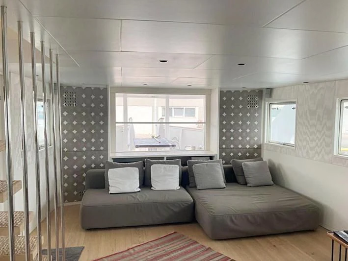 a large living room with a large bed and a large window aboard VIKA Yacht for Sale