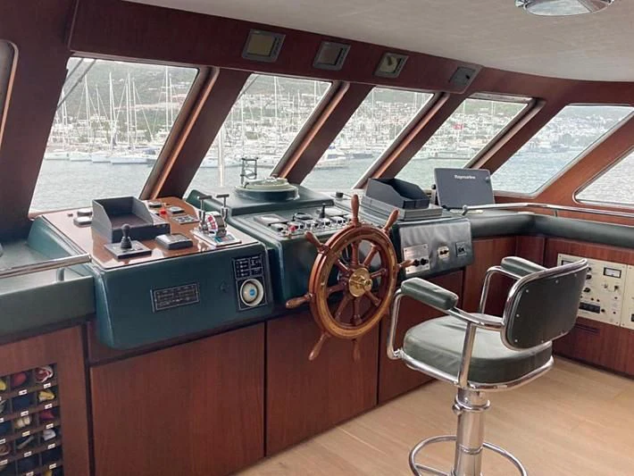 a room with a table and chairs aboard VIKA Yacht for Sale