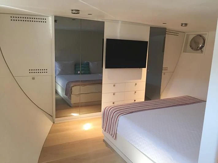 a room with a bed and a tv aboard VIKA Yacht for Sale
