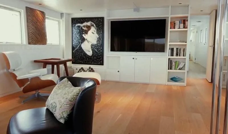 a living room with a large painting aboard VIKA Yacht for Sale