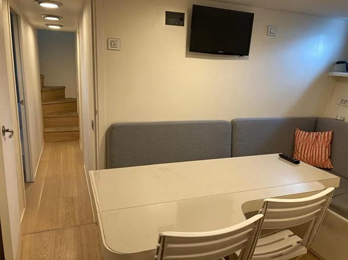 a living room with a couch and a television aboard VIKA Yacht for Sale