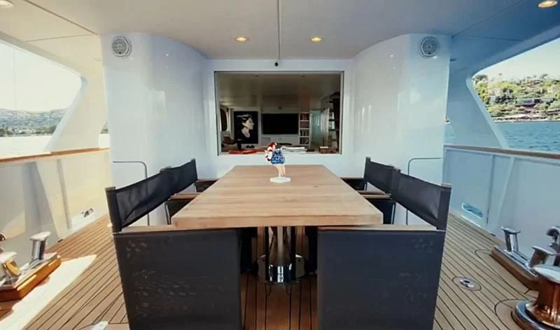 a room with a table and chairs aboard VIKA Yacht for Sale