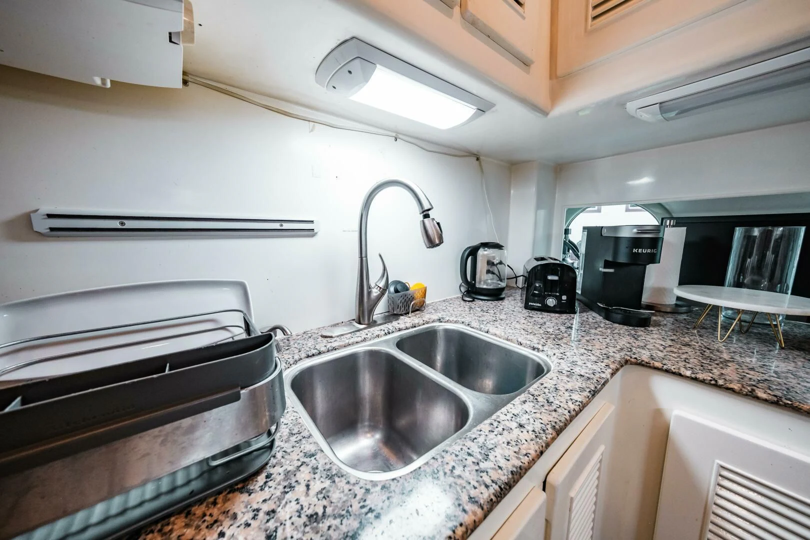 a kitchen with a sink and a stove aboard LADY GERTS Yacht for Sale