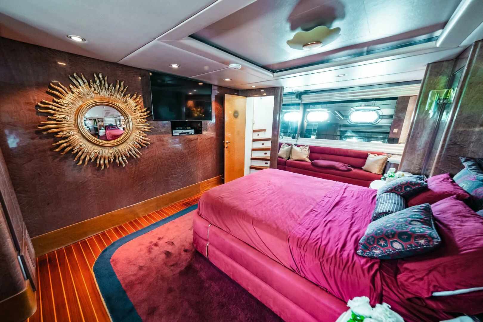 a room with a bed and a painting on the wall aboard LADY GERTS Yacht for Sale