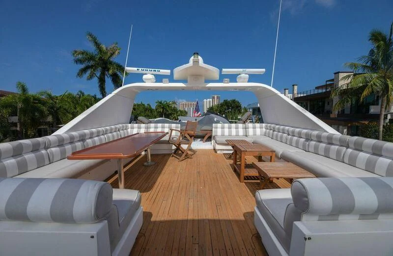 a deck with a pool and a building in the background aboard LADY GERTS Yacht for Sale