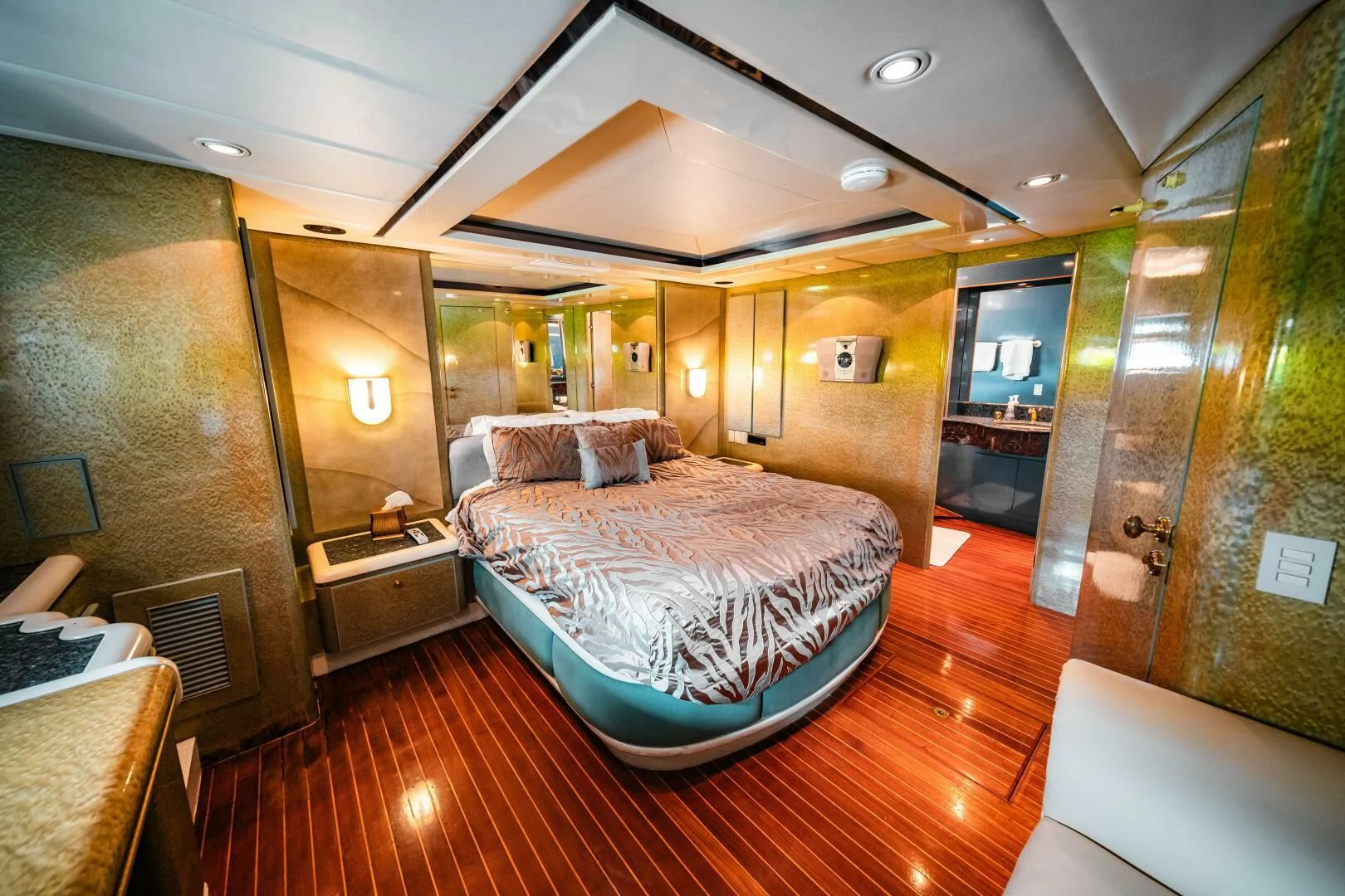 a bedroom with a bed and a table aboard LADY GERTS Yacht for Sale