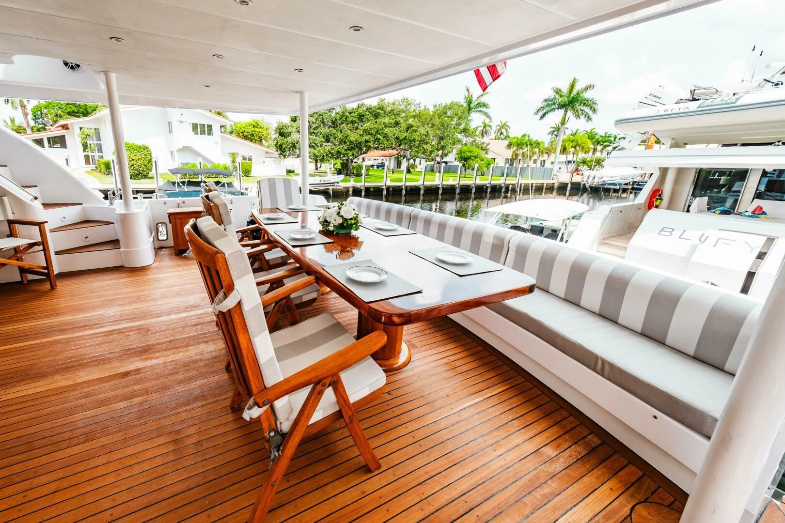 a table and chairs on a patio aboard LADY GERTS Yacht for Sale