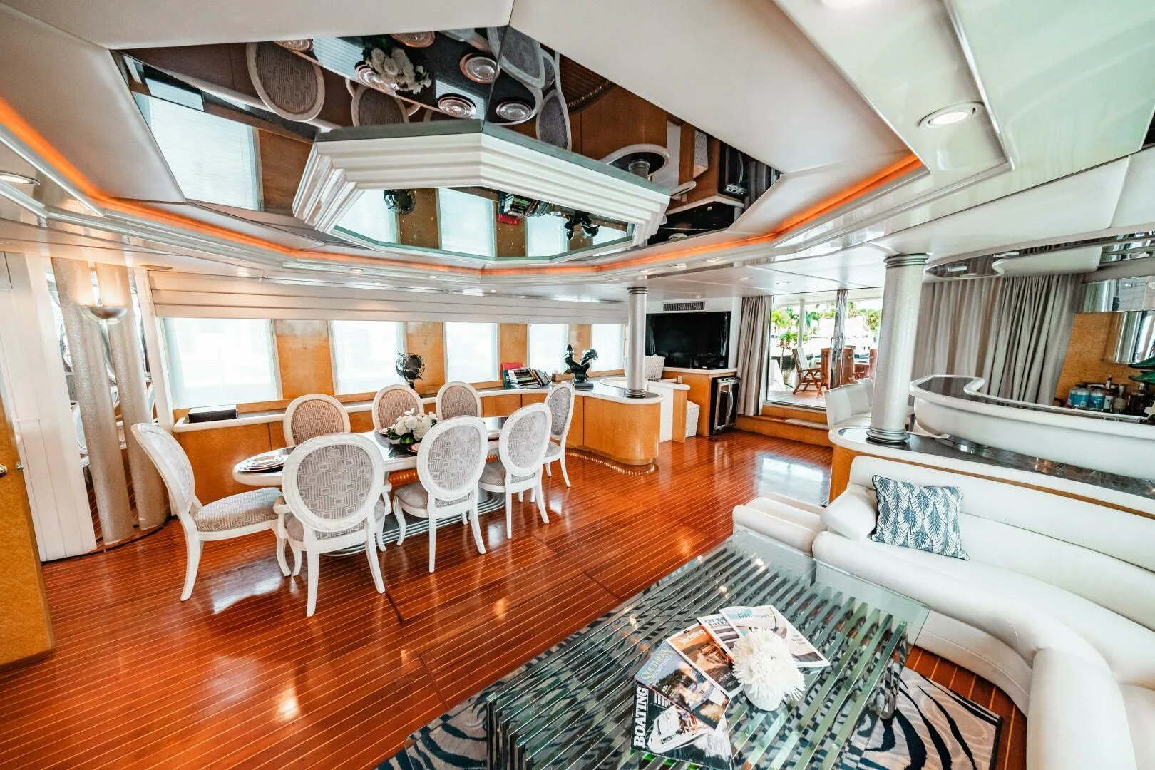a large living room with a dining table and chairs aboard LADY GERTS Yacht for Sale