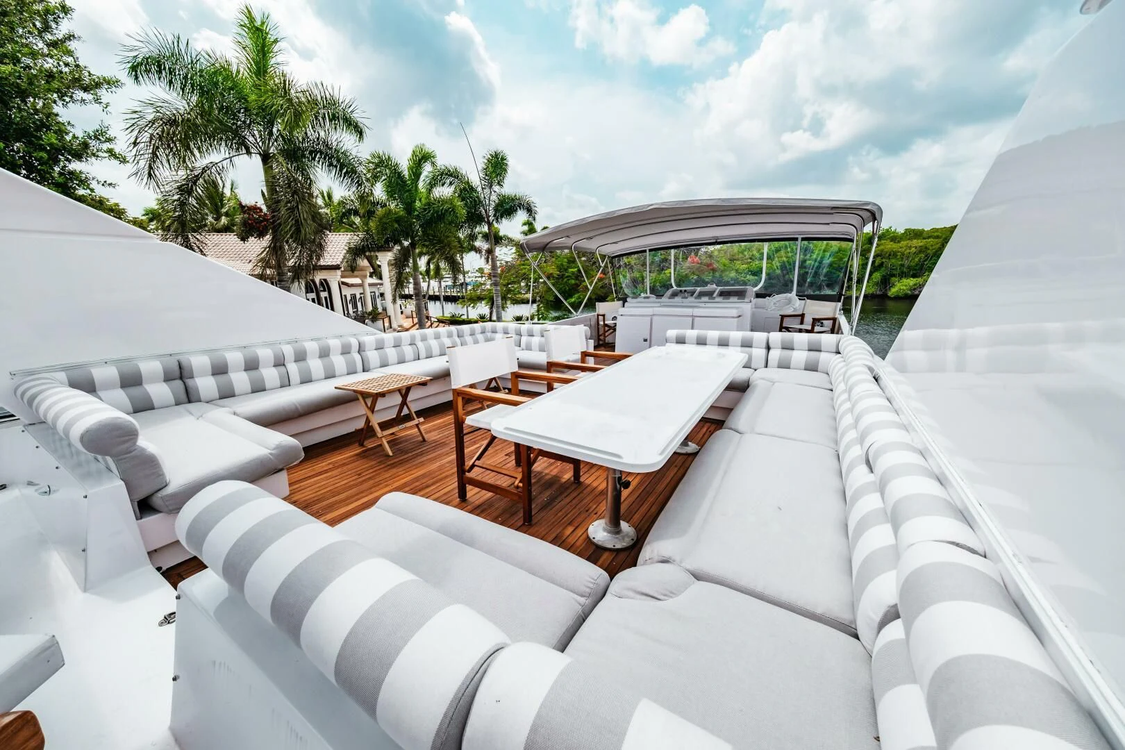 a lounge area with lounge chairs and a pool aboard LADY GERTS Yacht for Sale