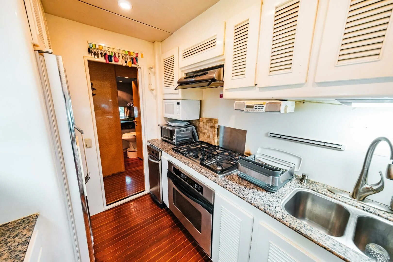 a kitchen with a stove and sink aboard LADY GERTS Yacht for Sale