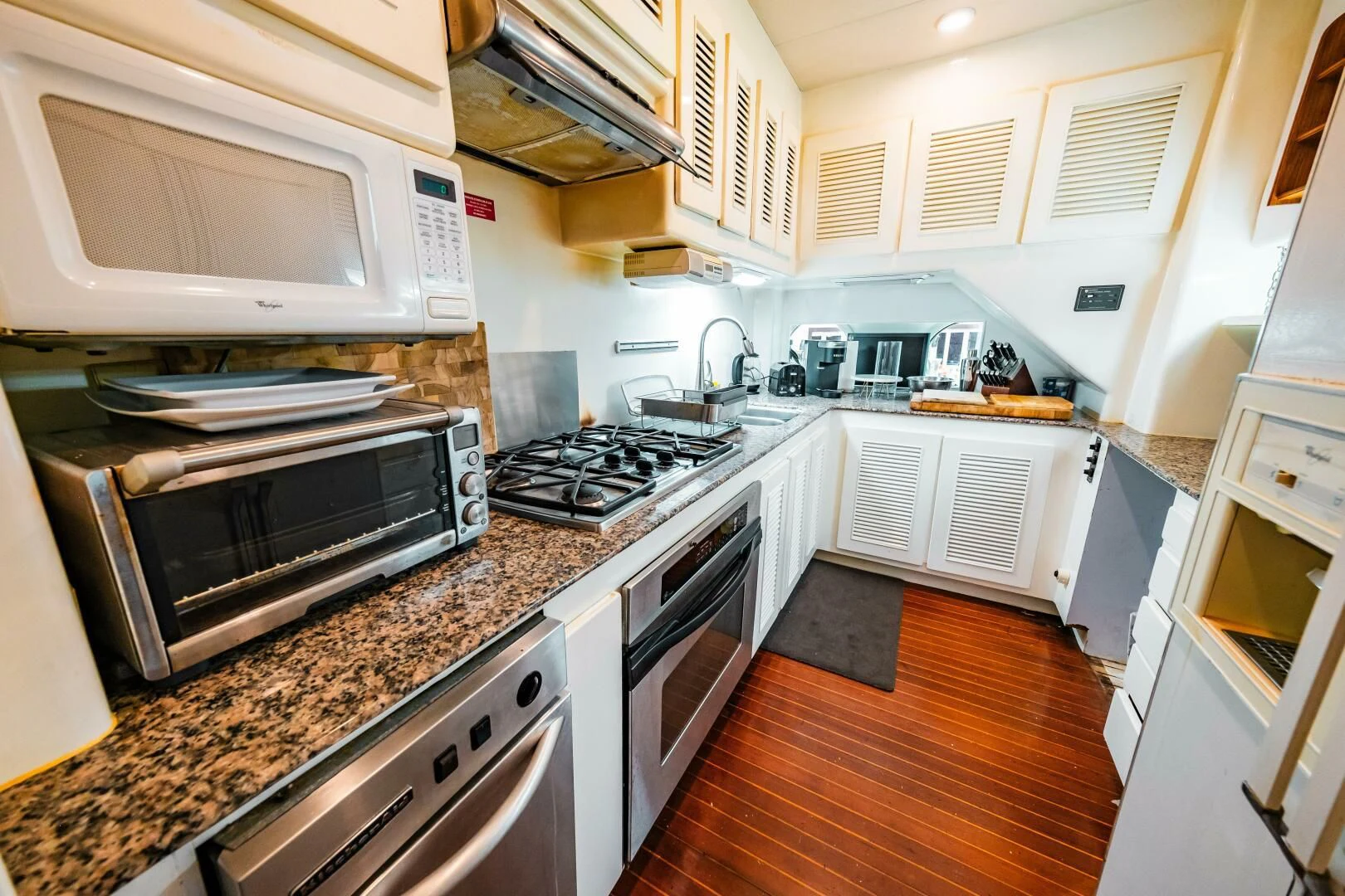a kitchen with white cabinets aboard LADY GERTS Yacht for Sale