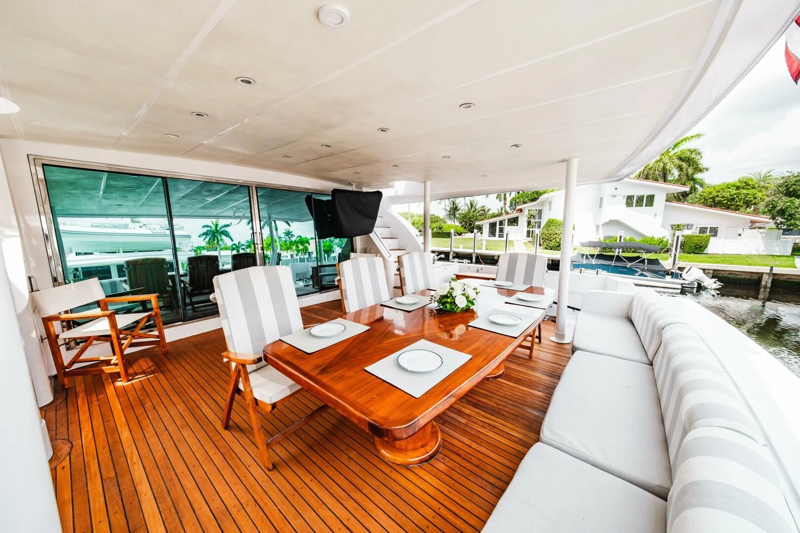 a room with a table chairs and a couch aboard LADY GERTS Yacht for Sale