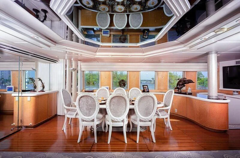 a room with tables and chairs aboard LADY GERTS Yacht for Sale