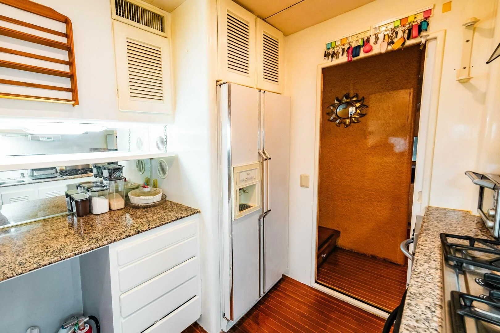 a kitchen with a fridge aboard LADY GERTS Yacht for Sale