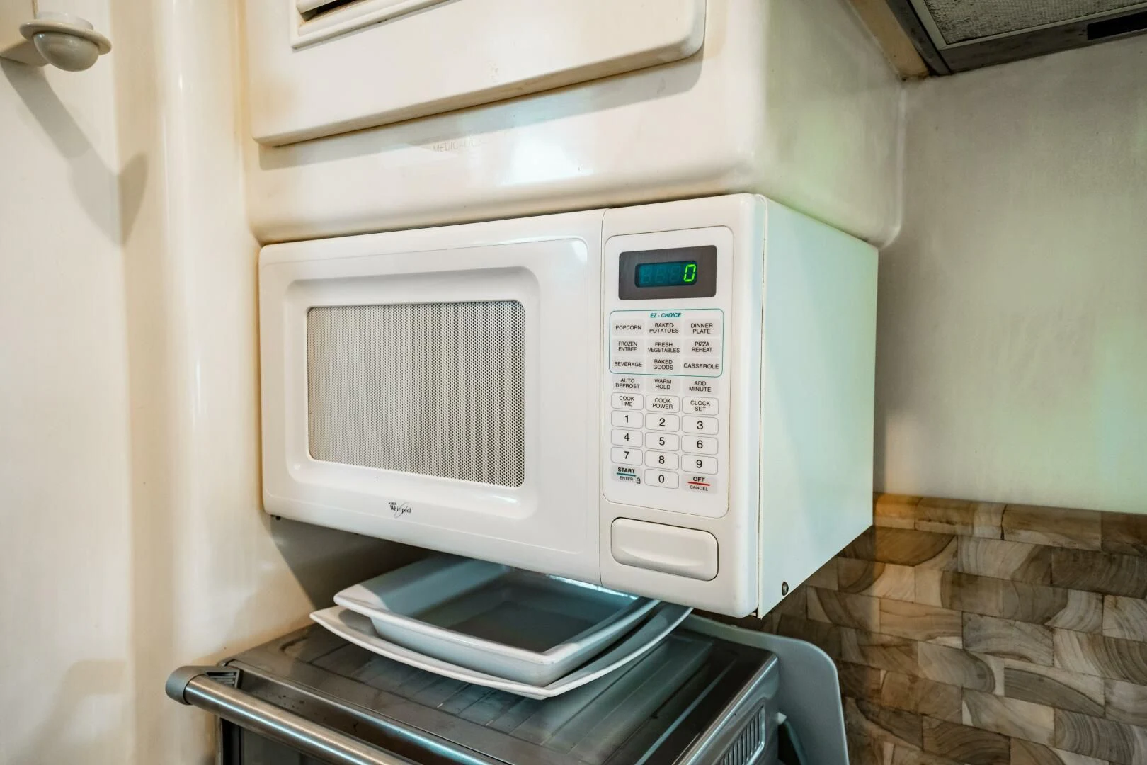 a microwave oven with a cell phone on top aboard LADY GERTS Yacht for Sale