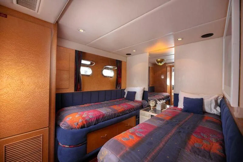 a room with beds and a mirror aboard LADY GERTS Yacht for Sale