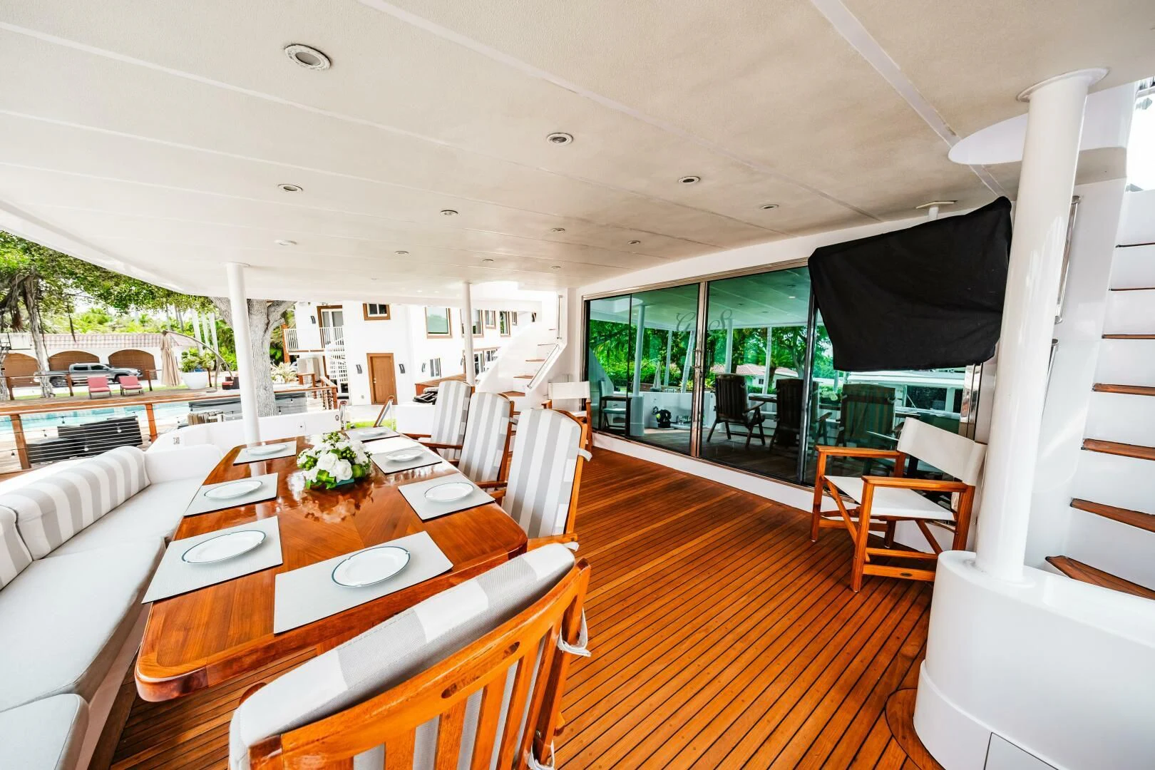 a dining table and chairs in a room with a large window aboard LADY GERTS Yacht for Sale