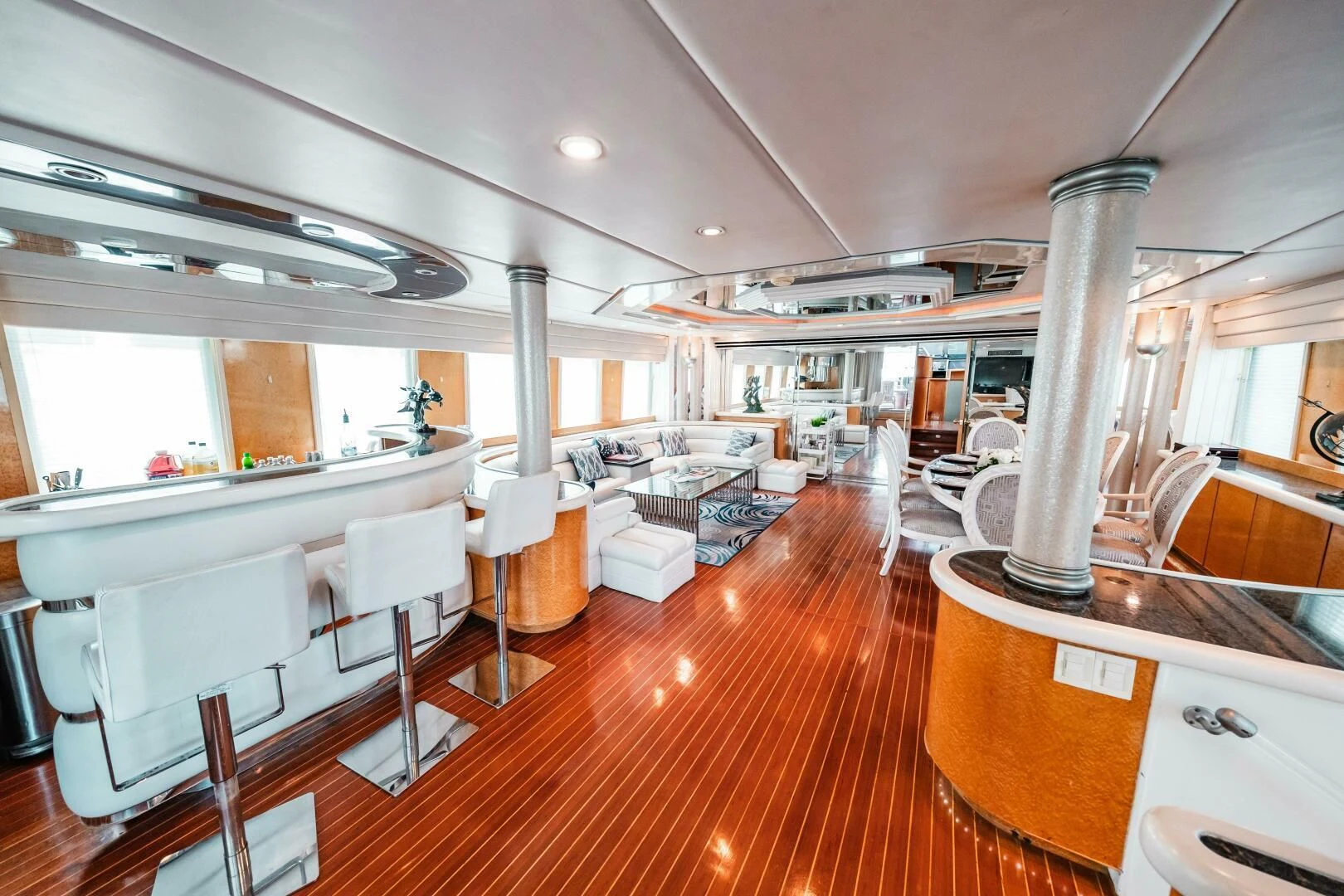 a room with a large table and chairs aboard LADY GERTS Yacht for Sale