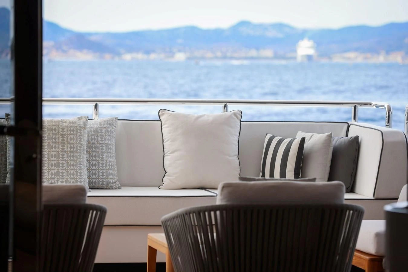 a room with a couch and a view of a city aboard MEDIALLY Yacht for Sale