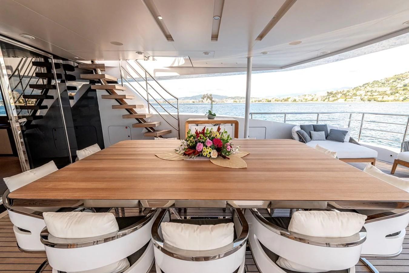 a table with chairs and a flower on it aboard MEDIALLY Yacht for Sale