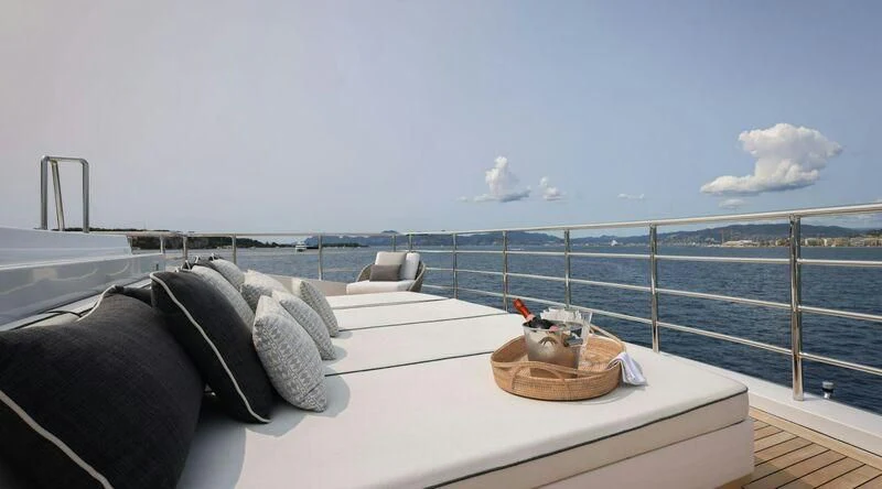 a bed with a tray of food on it aboard MEDIALLY Yacht for Sale