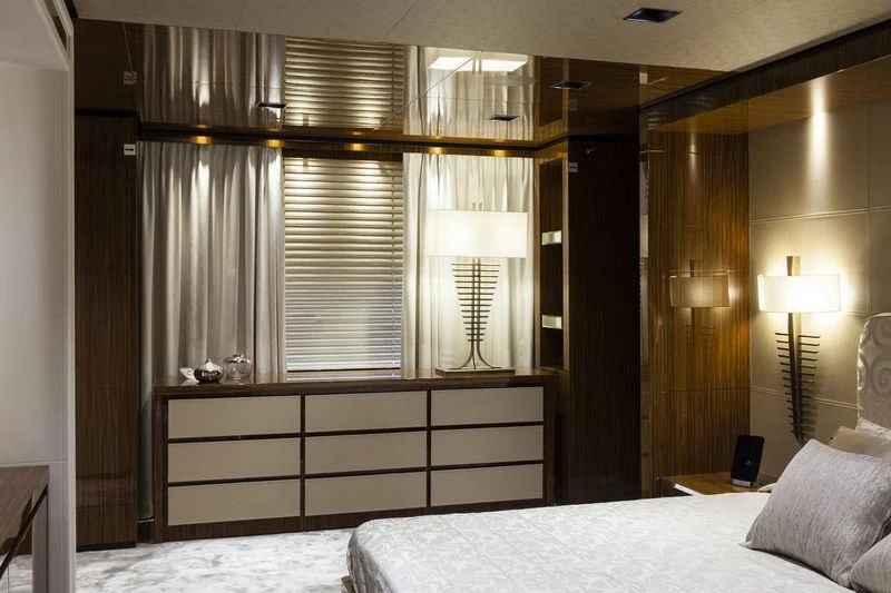 a bedroom with a bed and a desk aboard MEDIALLY Yacht for Sale