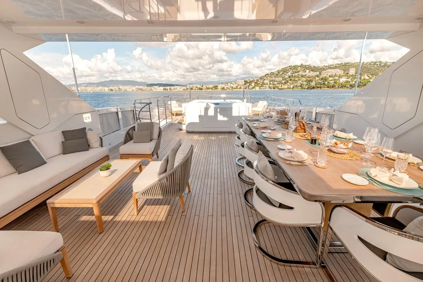 a room with a table chairs and a view of the water aboard MEDIALLY Yacht for Sale