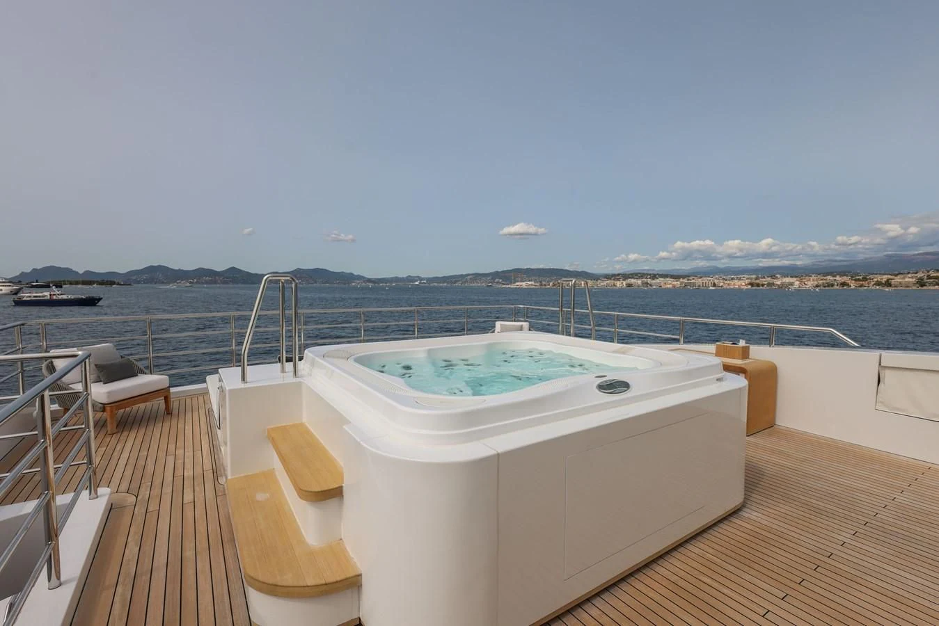 a large tub on a deck overlooking a large body of water aboard MEDIALLY Yacht for Sale