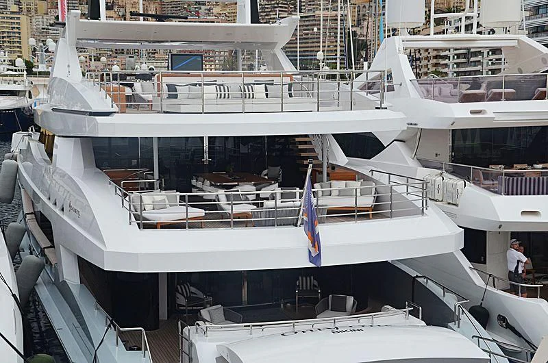 a large white boat with chairs and tables aboard MEDIALLY Yacht for Sale