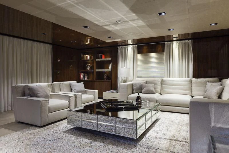 a living room with a glass coffee table and a couch aboard MEDIALLY Yacht for Sale