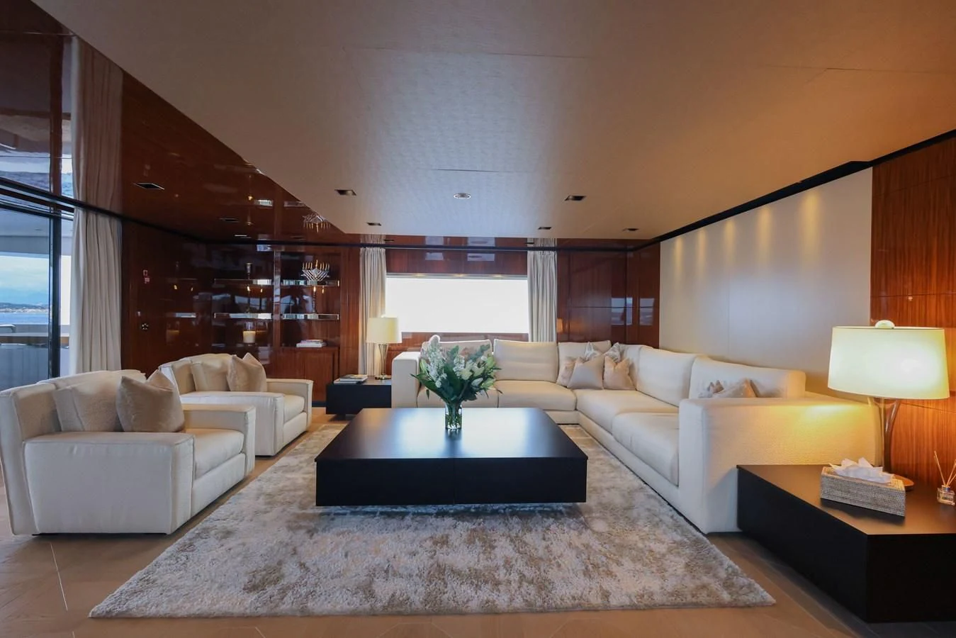 a large living room with a large white rug and a large window aboard MEDIALLY Yacht for Sale