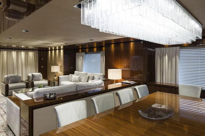 a large living room with a large table and couches aboard MEDIALLY Yacht for Sale