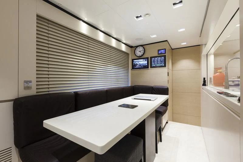 a room with a table and chairs aboard MEDIALLY Yacht for Sale