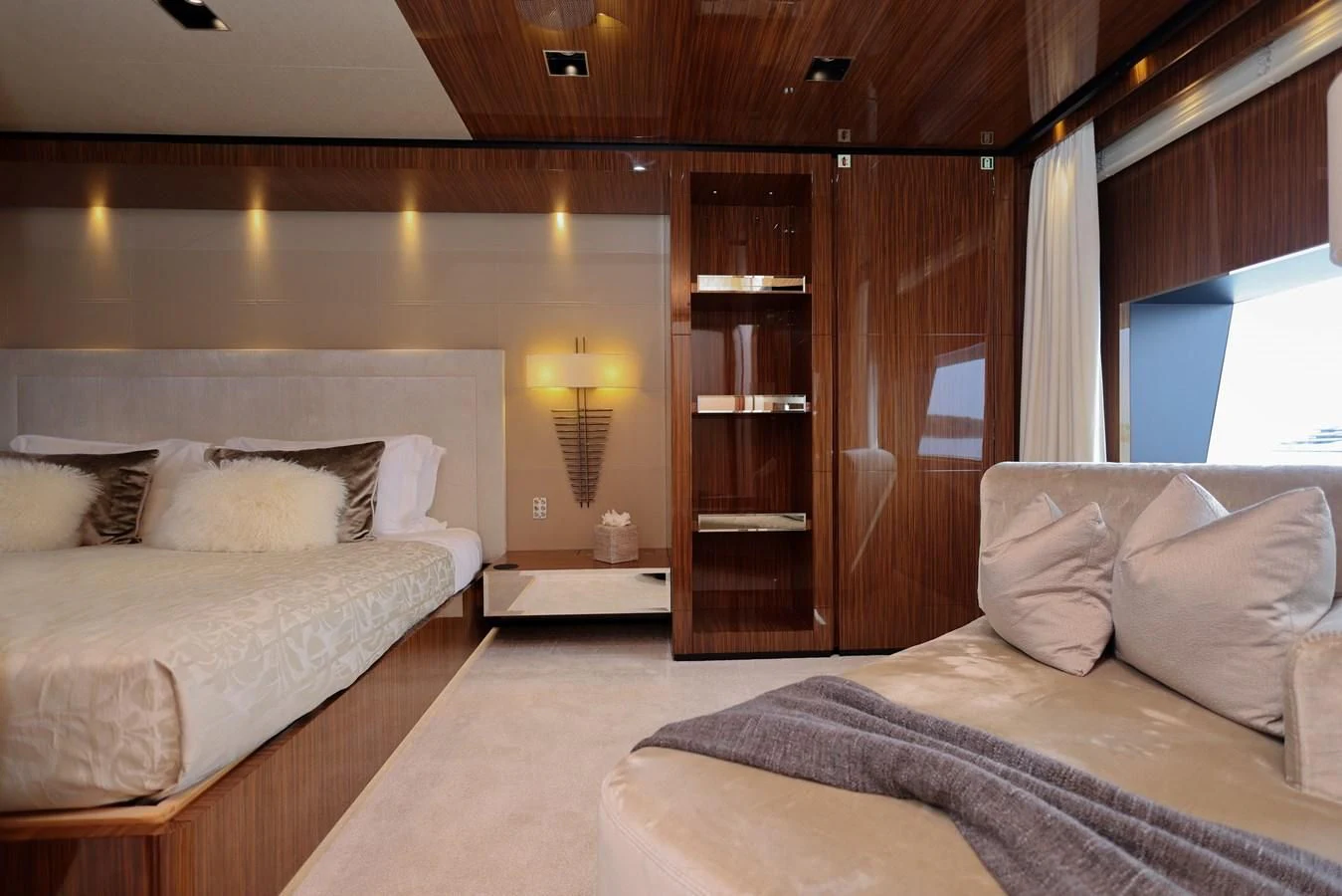 a room with a bed and a shelf with bookshelves aboard MEDIALLY Yacht for Sale