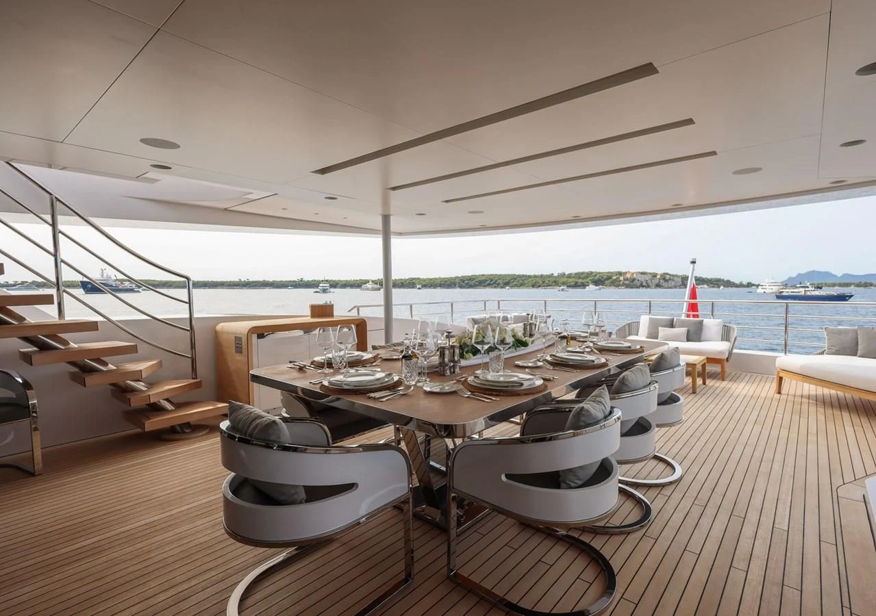 a table set for a meal on a deck aboard MEDIALLY Yacht for Sale