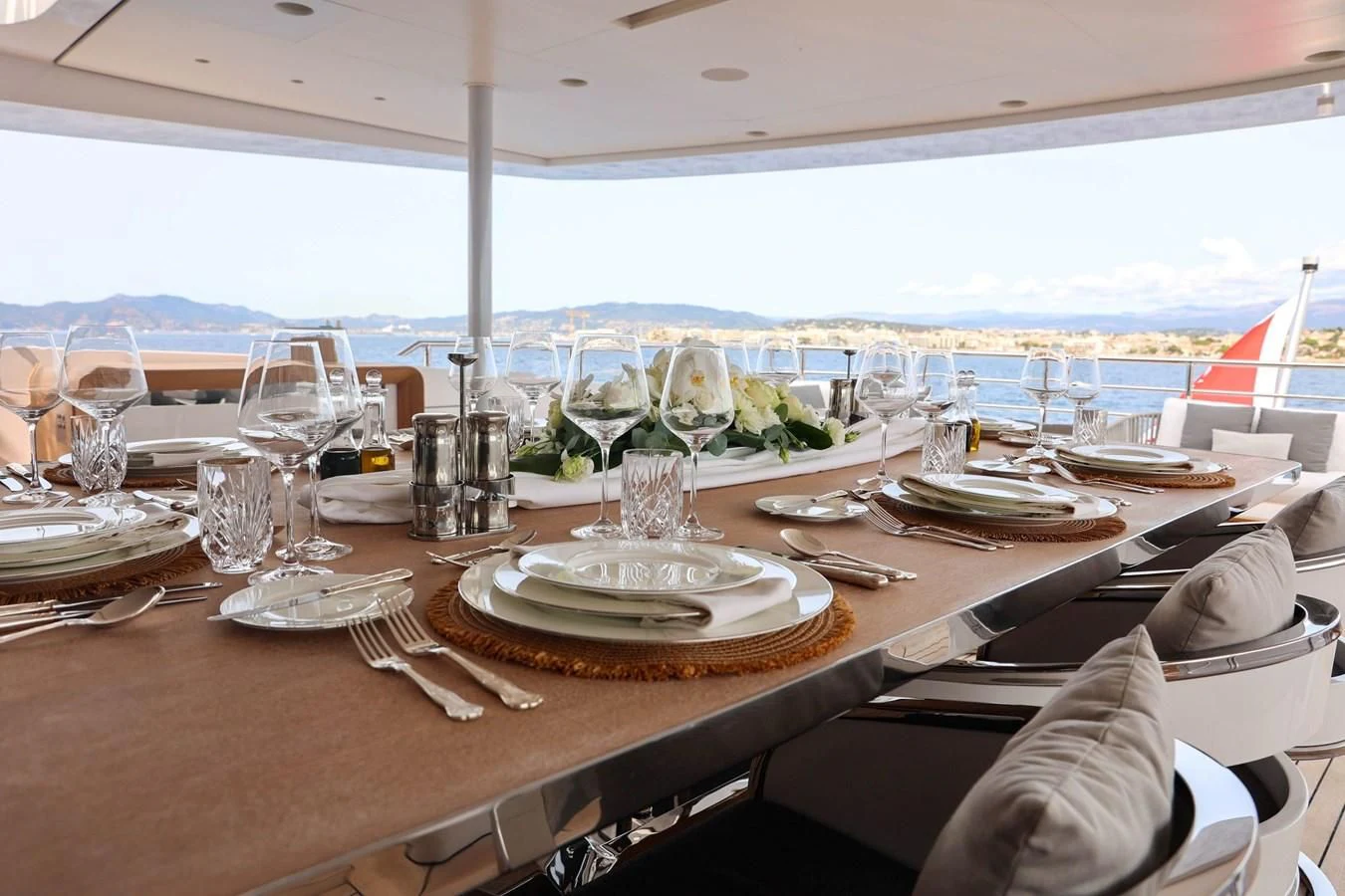 a table with plates and glasses on it aboard MEDIALLY Yacht for Sale