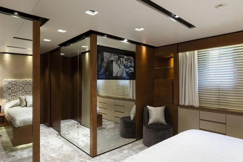 a room with a bed and a television aboard MEDIALLY Yacht for Sale