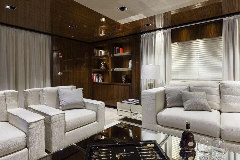 a living room with a glass table and a couch aboard MEDIALLY Yacht for Sale