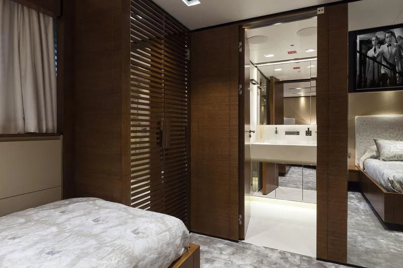 a room with a bed and a mirror aboard MEDIALLY Yacht for Sale
