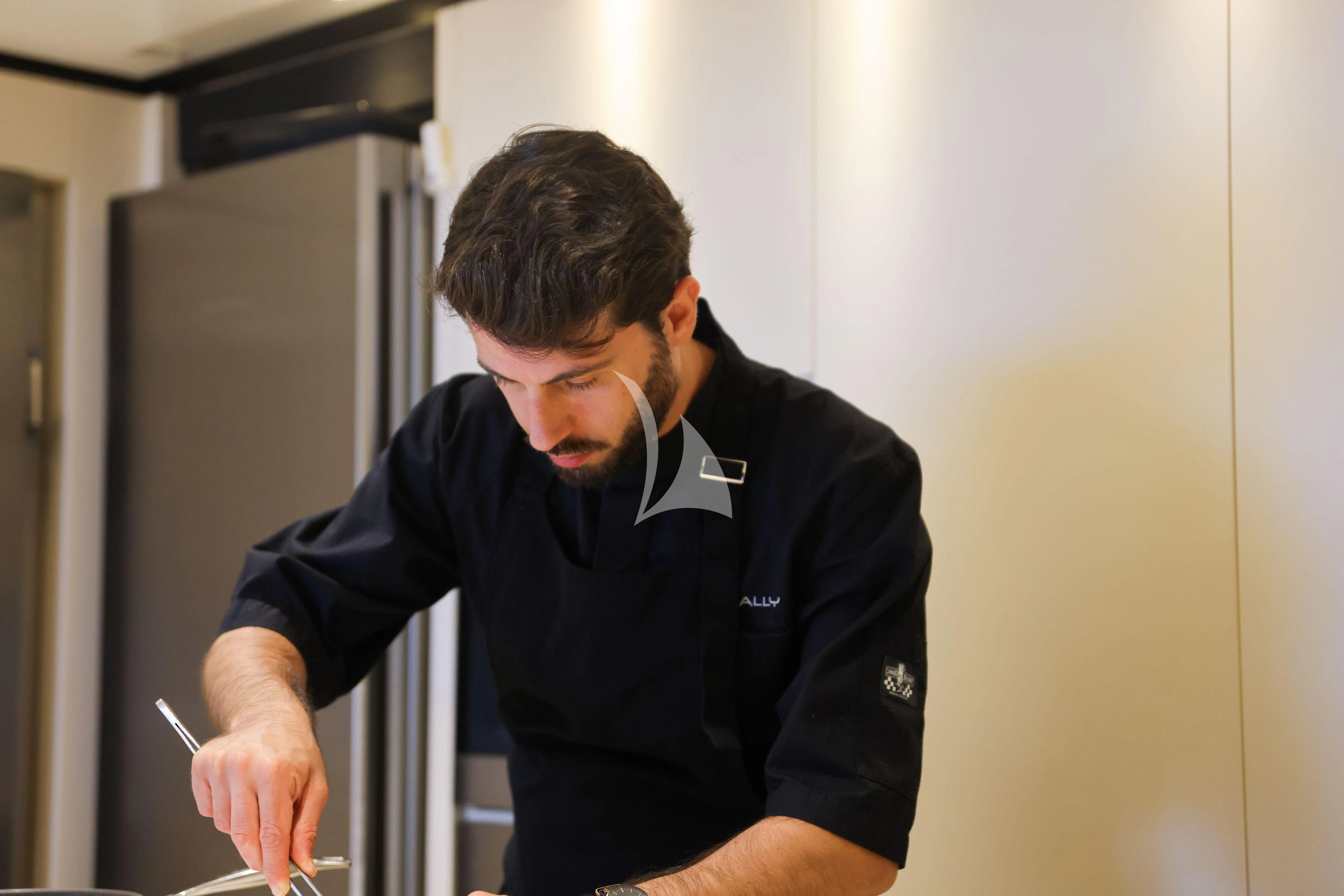 a man with a cigarette in his mouth aboard MEDIALLY Yacht for Sale
