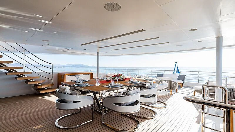 a room with a table and chairs aboard MEDIALLY Yacht for Sale